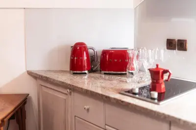 a kitchen with two red appliances on a counter at Historic lake view Bled apartment in Bled