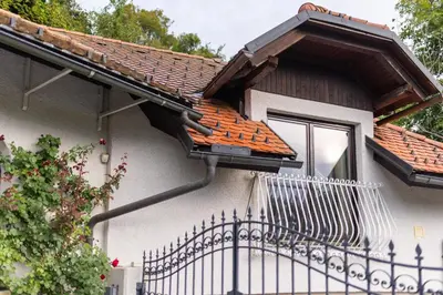 a house with a fence and a window at Historic lake view Bled apartment in Bled