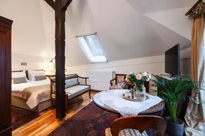 a living room with a bed and a table at Historic lake view Bled apartment in Bled