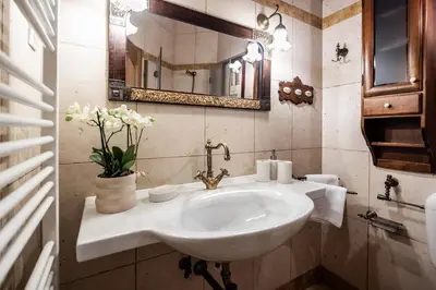 a bathroom with a sink and a mirror at Historic lake view Bled apartment in Bled
