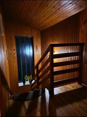 a room with a wooden wall and a window at Kopitnik cosy cabin in Dol pri Hrastniku