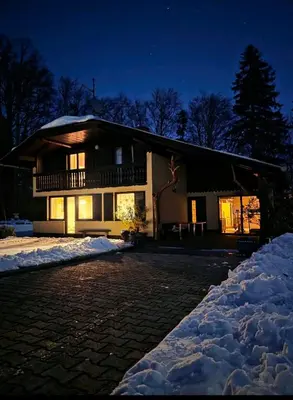 a house in the snow at night at Kopitnik cosy cabin in Dol pri Hrastniku