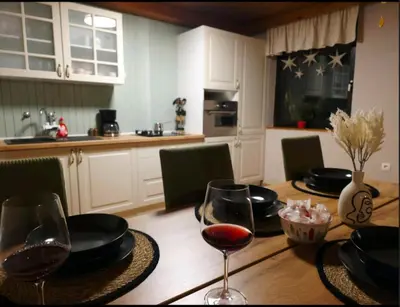 a dining room table with glasses of wine on it at Kopitnik cosy cabin in Dol pri Hrastniku