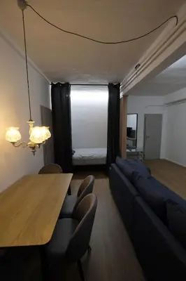 a living room with a table and a couch at Apartment Emona - Old Town Ljubljana in Ljubljana