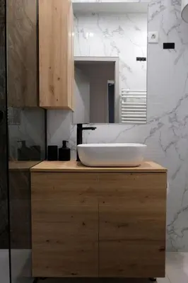 a bathroom with a white sink and a mirror at Apartment Emona - Old Town Ljubljana in Ljubljana