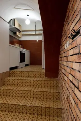 an empty room with a brick wall and stairs at Apartment Emona - Old Town Ljubljana in Ljubljana