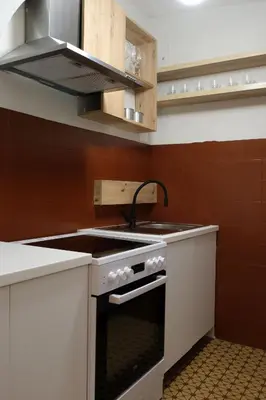 a kitchen with a stove and a sink at Apartment Emona - Old Town Ljubljana in Ljubljana