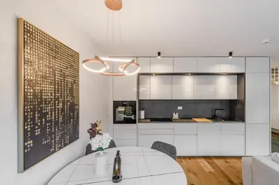a kitchen and dining room with a white table at Alps2sea Suite Apartment in Bovec