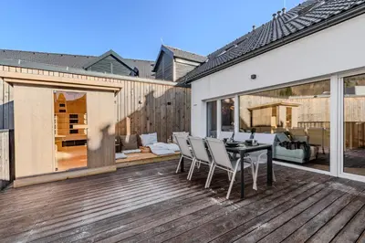 a patio with a table and chairs on a deck at Alps2sea Suite Apartment in Bovec
