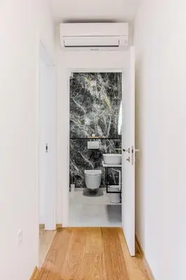 a bathroom with two toilets and a sink at Alps2sea Suite Apartment in Bovec