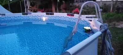 a swimming pool with a water slide in a yard at ROSE ROOM for 4 guests in Rose resort Ljubljana in Ljubljana