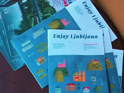 a stack of brochures on top of a table at ROSE ROOM for 4 guests in Rose resort Ljubljana in Ljubljana