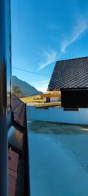 a view from a train window of a building at Apartma Mlinca 2 in Mojstrana