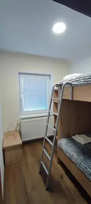 a ladder in a room with a bunk bed at Apartma Mlinca 2 in Mojstrana