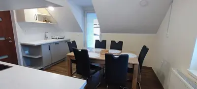 a kitchen and dining room with a table and chairs at Apartma Mlinca 2 in Mojstrana