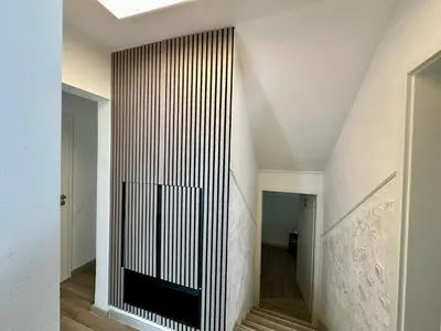 a hallway with a black and white striped wall at New LunarGlow 3-room Apartment with free parking in Ljubljana