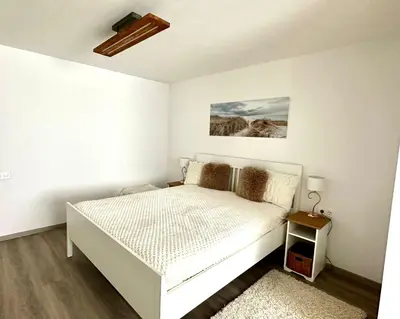 a white bedroom with a bed and a ceiling at New LunarGlow 3-room Apartment with free parking in Ljubljana