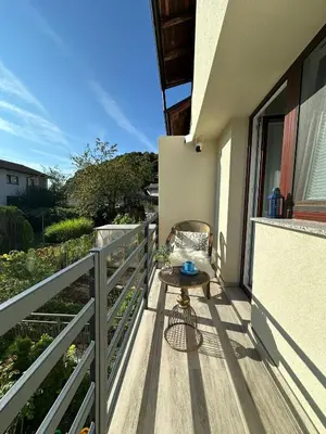 a small table on the balcony of a house at New LunarGlow 3-room Apartment with free parking in Ljubljana