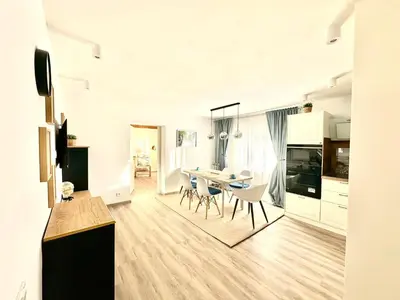 a kitchen and dining room with a table and chairs at New LunarGlow 3-room Apartment with free parking in Ljubljana