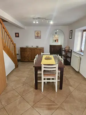 a dining room with a table and some chairs at Kraska hisa in Komen