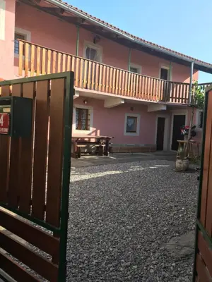 a house with a wooden gate and a picnic table at Kraska hisa in Komen