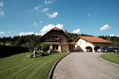 a house with a driveway in front of it at Kamp Nirvana in Šmartno ob Dreti