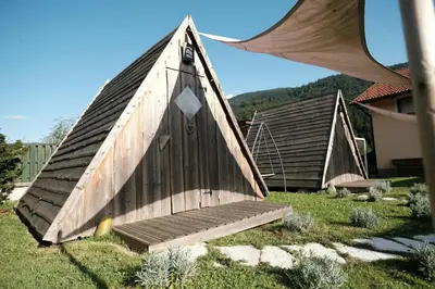 a small wooden boat sitting on top of a yard at Kamp Nirvana in Šmartno ob Dreti