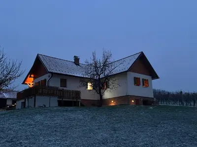 a large white house with a gambrel roof at Iža na brejgi in Moravske Toplice