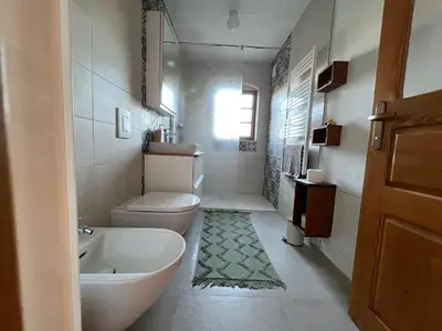 a bathroom with a toilet and a sink and a tub at Iža na brejgi in Moravske Toplice