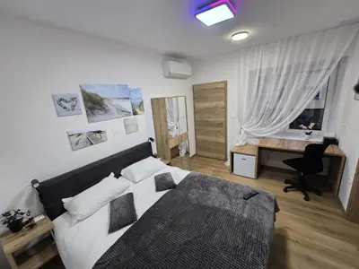 a bedroom with a bed and a desk in it at Prenočišca Dany 4 in Dravograd