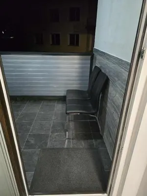 a black chair sitting on a tile floor in a room at Prenočišca Dany 4 in Dravograd
