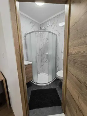 a bathroom with a glass shower with a toilet at Prenočišca Dany 4 in Dravograd