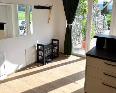 a kitchen with a black counter and a window at Pija's apartment, a quiet getaway close to Ljubljana in Vrhnika