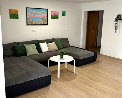 a living room with a couch and a table at Pija's apartment, a quiet getaway close to Ljubljana in Vrhnika