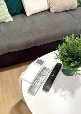 a coffee table with two remote controls on it at Pija's apartment, a quiet getaway close to Ljubljana in Vrhnika