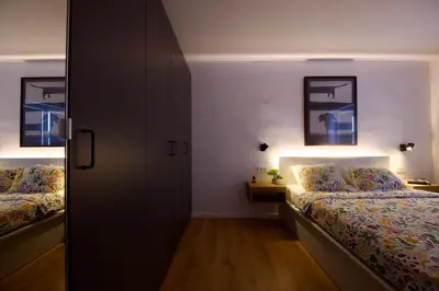 a small bedroom with two beds and a closet at Baguettes apartment in Oplotnica