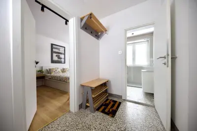 a small hallway with a door leading to a bedroom at Baguettes apartment in Oplotnica