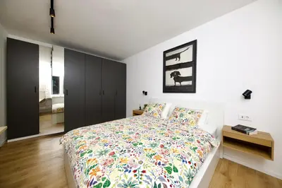 a bedroom with a large bed with a colorful bedspread at Baguettes apartment in Oplotnica