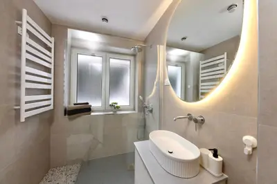 a bathroom with a sink and a mirror at Baguettes apartment in Oplotnica