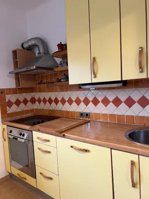 a kitchen with yellow cabinets and a sink at Being eco in Ljubljana in Ljubljana