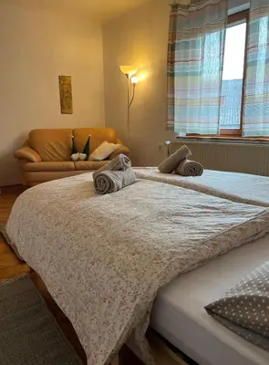 two large beds in a room with a couch at Being eco in Ljubljana in Ljubljana