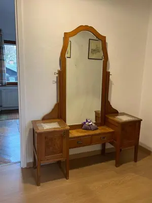 a dressing table with a mirror and two tables at Being eco in Ljubljana in Ljubljana