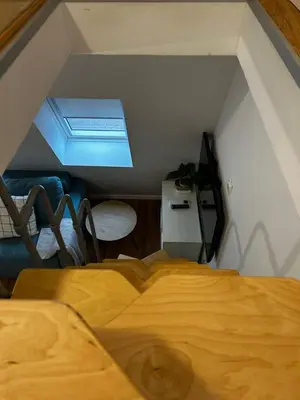 a bedroom with a wooden bed in a attic at Eluma Apartments Bovec in Bovec
