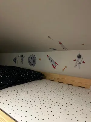 a bedroom with a bed with kites on the wall at Velvet Alps Bovec in Bovec