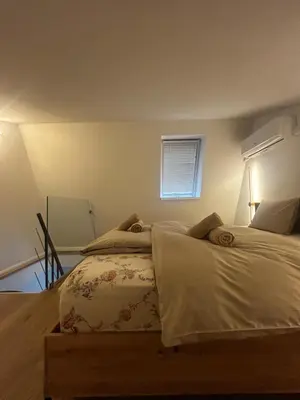 a bedroom with two beds and a window at Velvet Alps Bovec in Bovec