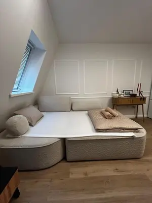 a large bed in a room with a window at Velvet Alps Bovec in Bovec