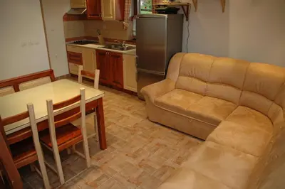 a living room with a couch and a table at Apartment Cokla Rogla in Zreče