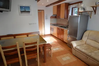 a kitchen with a table and a couch at Apartment Cokla Rogla in Zreče