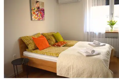 a couch with pillows on it in a room at Ahat apartment in Maribor