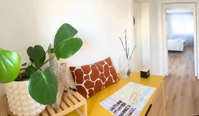 a room with a table with a plant on it at Ahat apartment in Maribor